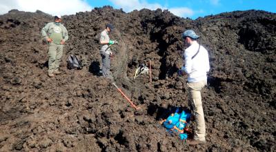 Fotografía sin fecha cedida por Benjamín Bernard que muestra a un equipo de expertos vulcanólogos mientras recogen muestras de flujos de lava solidificada en el Volcán Wolf con la ayuda de un guardaparques del Parque Nacional Galápagos.