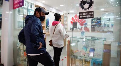 Personas en un local de celulares en un centro comercial del norte de Quito, en junio de 2020. 