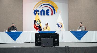 El coronel Jaime Navarrete, del IGM, y la presidenta del CNE, Diana Atamaint, en la suscripción del contrato este 2 de octubre de 2020.