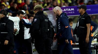 Félix Sánchez Bas sale de la cancha del estadio Rodrigo Paz Delgado con protección policial, después de la victoria de Ecuador ante Chile, por 1 a 0, el 21 de noviembre de 2023. 