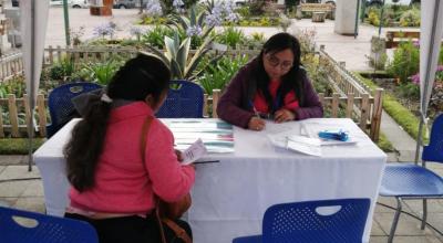 Una mujer recibe información sobre la bolsa de empleo del Ministerio de Trabajo, en una feria realizada en Azuay, en julio de 2023. 